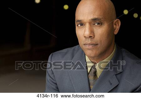 Portrait of young businessman outdoors at night View Large Photo Image Stock Photograph - Portrait of young businessman outdoors at night. Fotosearch