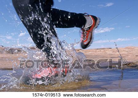 Running through a puddle View Large Photo Image Stock Image - Running through a puddle. Fotosearch