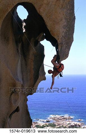 Side profile of a man hanging upside down on a cliff View Large Photo Image Stock Image - Side profile of a man hanging upside down on a cliff. Fotosearch