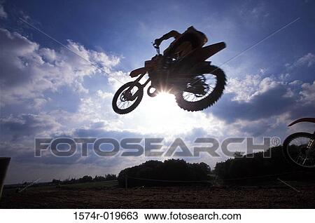 Silhouette of a person performing stunts on a motorcycle View Large Photo Image Stock Image - Silhouette of a person performing stunts on a motorcycle. Fotosearch