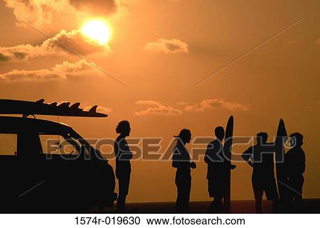 Silhouette of five people standing with surfboards at dusk View Large Photo Image Stock Image - Silhouette of five people standing with surfboards at dusk. Fotosearch