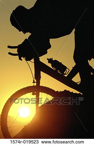 Silhouette of person mountain biking View Large Photo Image Stock Image - Silhouette of person mountain biking. Fotosearch