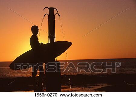 Silhouette of person showering after surfing at sunset, Hawaii, USA View Large Photo Image Stock Image - Silhouette of person showering after surfing at sunset, Hawaii, USA. Fotosearch