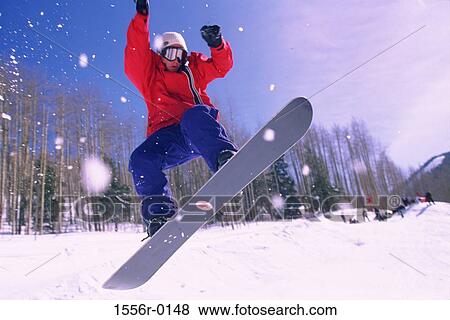 Teenager performing stunt on snowboard View Large Photo Image Stock Photo - Teenager performing stunt on snowboard. Fotosearch