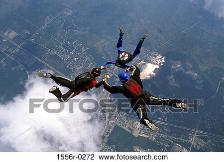 Three people skydiving View Large Photo Image Stock Image - Three people skydiving. Fotosearch