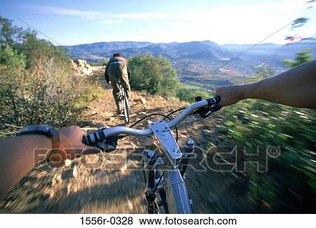 Two people mountain biking View Large Photo Image Stock Photo - Two people mountain biking. Fotosearch