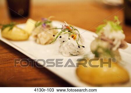 Stock Image - USA, New York City, Manhattan, close up of assorted pickled herring. Fotosearch
