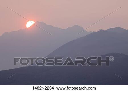 USA, Washington State, Seabeck, view across Hood Canal to the Olympic Mountains at sunset with forest fire smoke in air View Large Photo Image Picture - USA, Washington State, Seabeck, view across Hood Canal to the Olympic Mountains at sunset with forest fire smoke in air. Fotosearch