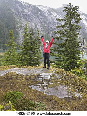 Woman cheering after reaching the top of mountain, Endicott Arm, Alaska, USA View Large Photo Image Stock Photography - Woman cheering after reaching the top of mountain, Endicott Arm, Alaska, USA. Fotosearch
