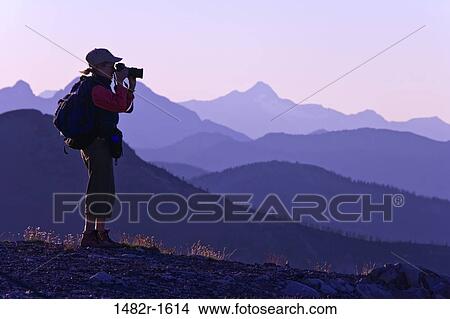 Woman taking a picture with a camera, Slate Peak, Pasayten Wilderness, Okanogan National Forest, Washington State, USA View Large Photo Image Picture - Woman taking a picture with a camera, Slate Peak, Pasayten Wilderness, Okanogan National Forest, Washington State, USA. Fotosearch