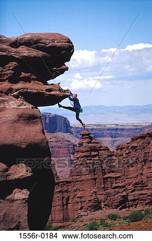 Picture - Young adult man mountain climbing, Utah, USA. Fotosearch
