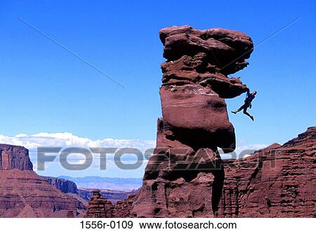 Stock Photo - Young adult man mountain climbing, Utah, USA. Fotosearch