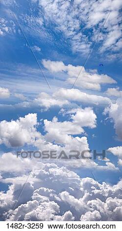 Blue sky, clouds, and Paraglider (digital composite) View Large Photo Image Stock Photo - Blue sky, clouds, and Paraglider (digital composite). Fotosearch