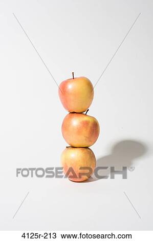 Organic empire apples stacked up balanced on white background View Large Photo Image Stock Image - Organic empire apples stacked up balanced on white background. Fotosearch