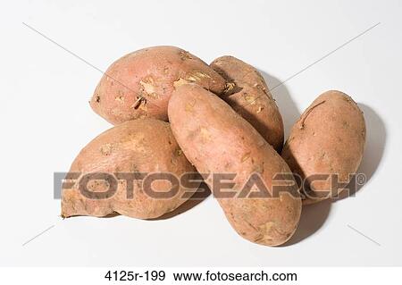 Stock Photo - Organic Sweet Potato Yams in pile on white background. Fotosearch