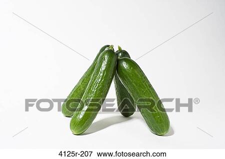 Persian organic cucumbers standing up balanced on white background View Large Photo Image Stock Photo - Persian organic cucumbers standing up balanced on white background. Fotosearch