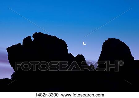 Stock Image - USA, California, Alabama Hills, near Lone Pine, Crescent moon and predawn sky. Fotosearch