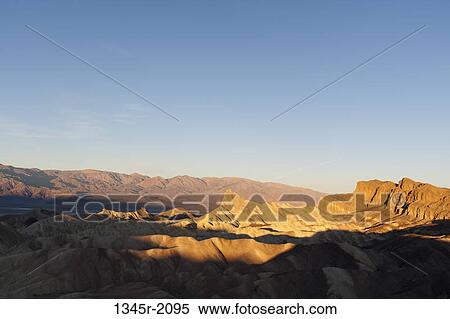 Stock Photography - USA, California, Death Valley National Park, Zabriskie Point in sunlight. Fotosearch