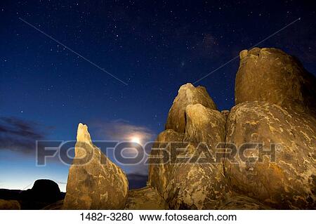 Stock Image - USA, California, Predawn sky with moon, Alabama Hills, near Lone Pine. Fotosearch