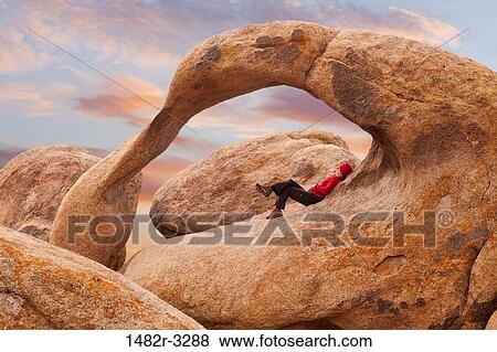 USA, California, Reclining woman under Arch, Alabama Hills, near Lone Pine View Large Photo Image Stock Photo - USA, California, Reclining woman under Arch, Alabama Hills, near Lone Pine. Fotosearch