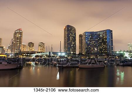 Stock Photograph - USA, California, San Diego, Marina and skyline at dusk. Fotosearch