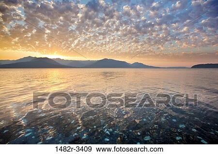 Stock Photo - USA, Washington State, Sunset, Olympic Mountains and Hood Canal taken from Seabeck. Fotosearch