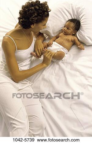 bed, people, baby, mother, playing, playful, attentive View Large Photo Image Stock Photo - bed, people, baby, mother, playing, playful, attentive. Fotosearch