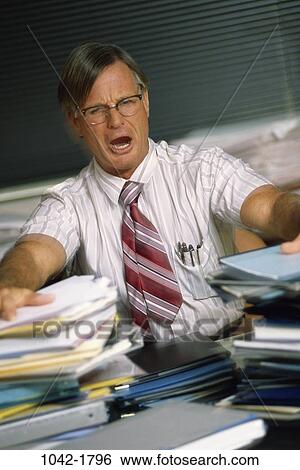 desk, anger, paperwork, eyeglasses, papers, overwhelmed View Large Photo Image Stock Photograph - desk, anger, paperwork, eyeglasses, papers, overwhelmed. Fotosearch