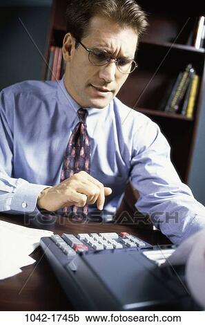 Stock Image - desk, business, businessman, indoors, Businessmen indoors desk. Fotosearch