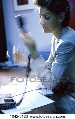 desk, woman, telephone, phone, speed, contemplation, serious View Large Photo Image Stock Image - desk, woman, telephone, phone, speed, contemplation, serious. Fotosearch