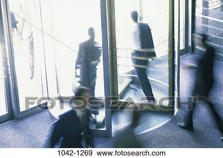 Stock Photo - door, revolving door, motion, business, chaotic, exiting. Fotosearch