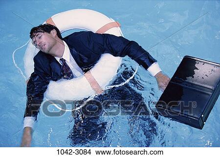 Picture - drowning, briefcase, business, concepts, challenges, defeat. Fotosearch