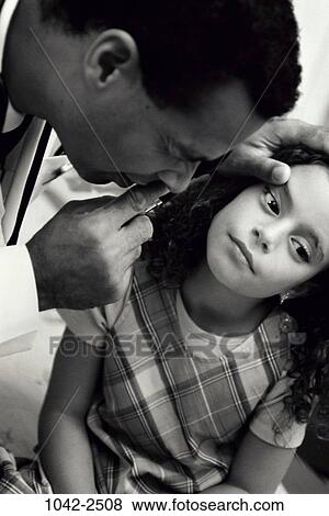 Stock Photo - eye, Hispanic, patient, doctor, health, indoors, pediatrics. Fotosearch
