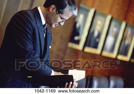 Stock Photo - eyeglasses, reading, business, Middle-aged, businessman, indoors. Fotosearch