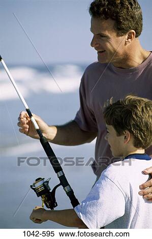 Stock Photography - fish, people, beach, fishing, fishing pole, hobbies, family. Fotosearch