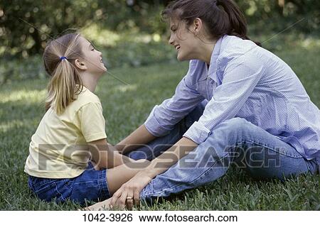 grass, people, smiling, ground, talking, sitting View Large Photo Image Stock Photograph - grass, people, smiling, ground, talking, sitting. Fotosearch