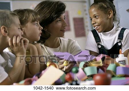 Stock Image - group, multiethnic, people, paper, teacher, school, arts. Fotosearch