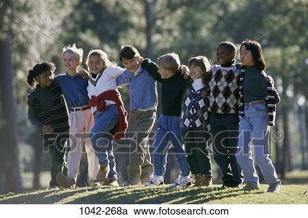 Stock Image - group, multiethnic, people, smiling, playful, trees. Fotosearch