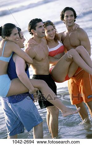 Picture - group, people, Hispanic, beach, playful, friends, vacation. Fotosearch