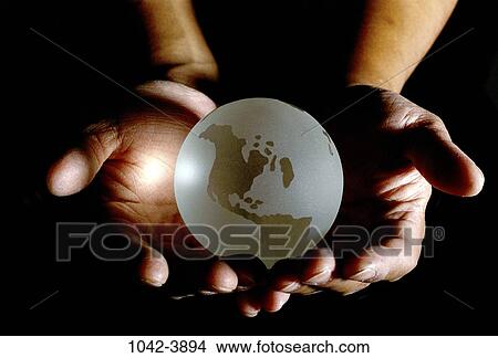 Picture - hand, globe, god, holding, risk, control, Earth. Fotosearch