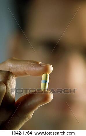 hand, pill, holding, health, medicine, challenges, confrontation View Large Photo Image Picture - hand, pill, holding, health, medicine, challenges, confrontation. Fotosearch