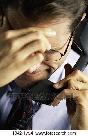 headache, telephone, talking, eyeglasses, phone, anxiety View Large Photo Image Picture - headache, telephone, talking, eyeglasses, phone, anxiety. Fotosearch