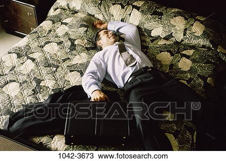 Stock Image - hotel, bed, business, relaxing, freedom, businessman. Fotosearch