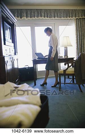 Stock Photo - hotel, woman, senior, computer, laptop, business. Fotosearch