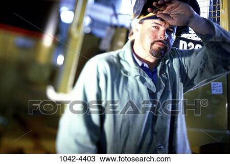 Stock Image - industry, industrial, trade, welder, blue collar, sweating. Fotosearch
