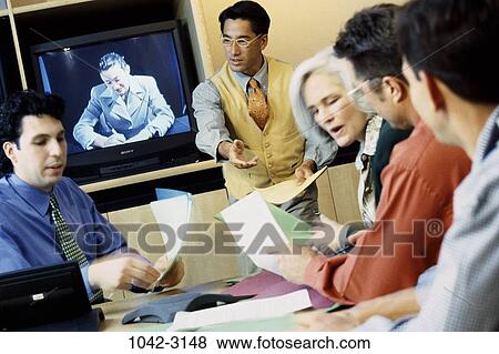 Stock Photo - meeting, group, multiethnic, blur, laptop, motion. Fotosearch