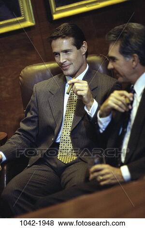 Stock Photo - meeting, men, cigar, smoke, celebration, business, executives. Fotosearch
