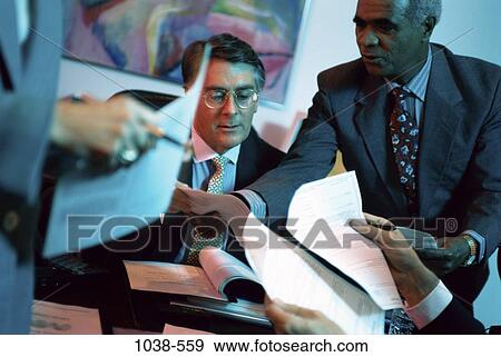 meeting, multiethnic, men, desk, paperwork, busy, overwhelmed View Large Photo Image Stock Photo - meeting, multiethnic, men, desk, paperwork, busy, overwhelmed. Fotosearch