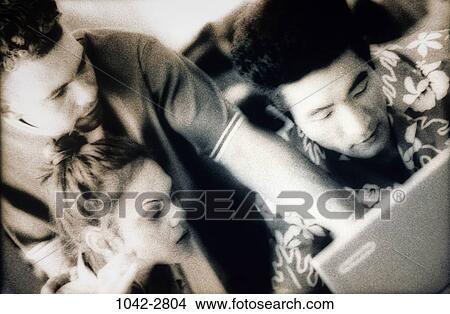 Picture - men, attentive, woman, listening, sitting, typing, concentrating. Fotosearch