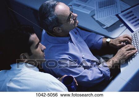 Stock Photograph - men, desk, coworkers, computer, typing, business. Fotosearch